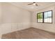 Empty bedroom with hardwood floors, wainscoting and a bright window at 3021 N 47Th St, Phoenix, AZ 85018