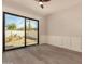 Empty bedroom with hardwood floors, wainscoting and a large sliding glass door that lets in plenty of natural light at 3021 N 47Th St, Phoenix, AZ 85018
