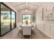 Elegant dining room featuring a modern chandelier, large windows, and stylish decor at 3021 N 47Th St, Phoenix, AZ 85018
