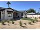 Charming home exterior with desert landscaping, a small lawn, black-framed windows, and a well-maintained facade at 3021 N 47Th St, Phoenix, AZ 85018
