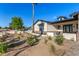 Inviting single-Gathering home featuring modern design, desert landscaping, brick accents, and a paved walkway at 3021 N 47Th St, Phoenix, AZ 85018