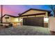 Beautiful single-Gathering home exterior with a spacious driveway and modern garage door under a colorful sunset at 3021 N 47Th St, Phoenix, AZ 85018