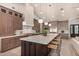 Spacious kitchen with a marble countertop island, stainless steel appliances, and hardwood floors at 3021 N 47Th St, Phoenix, AZ 85018
