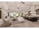 Open-concept living space with fireplace, island seating, and sliding doors to the outdoor area at 3021 N 47Th St, Phoenix, AZ 85018