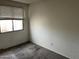 Simple bedroom with gray carpet and a window with blinds at 3120 N 67Th Ln # 42, Phoenix, AZ 85033