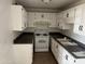 White kitchen cabinets, dark countertops, and electric range at 3120 N 67Th Ln # 42, Phoenix, AZ 85033
