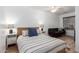 Comfortable bedroom with striped bedding and a small sofa at 428 N Mahogany Ct, Gilbert, AZ 85233