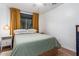 Bright bedroom with mustard curtains and a light green comforter at 428 N Mahogany Ct, Gilbert, AZ 85233