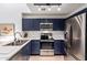 Stylish kitchen featuring dark blue cabinets and white backsplash at 428 N Mahogany Ct, Gilbert, AZ 85233