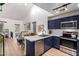 Updated kitchen with dark blue cabinetry and stainless steel appliances at 428 N Mahogany Ct, Gilbert, AZ 85233