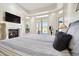 Well-lit main bedroom with a fireplace, trey ceiling, and views of the outdoor water feature at 4361 S Slow Pony Cir, Gold Canyon, AZ 85118