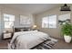 Virtually staged main bedroom with neutral decor and ensuite bathroom at 4483 N 203Rd Ave, Buckeye, AZ 85396