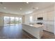 Open concept kitchen with island, stainless steel appliances, and wood flooring at 4483 N 203Rd Ave, Buckeye, AZ 85396