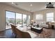 Virtually staged living room with sliding glass doors to the backyard at 4483 N 203Rd Ave, Buckeye, AZ 85396