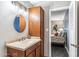 Bathroom with wood vanity, tiled floors, and a large mirror at 4809 N 78Th Pl, Scottsdale, AZ 85251