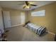 Simple bedroom with carpeting, double doors, and a twin bed at 4830 S 22Nd Pl, Phoenix, AZ 85040