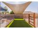 Fenced dog run with artificial turf and shade sail at 497 N Superstition Blvd, Chandler, AZ 85225