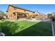 Artificial turf backyard with a pool and patio area at 6025 E Palomino Ln, Scottsdale, AZ 85266