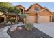 Two-story house with stone accents and a landscaped front yard at 6025 E Palomino Ln, Scottsdale, AZ 85266