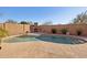 Kidney-shaped pool with a built-in fire pit and patio at 6025 E Palomino Ln, Scottsdale, AZ 85266