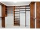 Large walk-in closet with wood shelving and hanging rods at 6025 E Palomino Ln, Scottsdale, AZ 85266