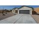 Newly built home with a gray garage door and desert landscaping at 6128 S Sage Way, Gold Canyon, AZ 85118