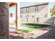 House with grassy backyard, patio, and block wall at 7 N 87Th Dr, Tolleson, AZ 85353