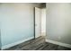 Bedroom with wood-look floors and an open door at 7 N 87Th Dr, Tolleson, AZ 85353