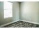 Simple bedroom with wood-look floors and window at 7 N 87Th Dr, Tolleson, AZ 85353