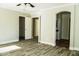 Bright bedroom featuring wood-look floors and ceiling fan at 7 N 87Th Dr, Tolleson, AZ 85353