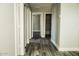 Long hallway with wood-look floors and access to bedrooms and bathrooms at 7 N 87Th Dr, Tolleson, AZ 85353