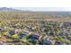 Expansive aerial shot of desert homes and landscaping nestled at the base of the mountains at 7278 E La Junta Rd, Scottsdale, AZ 85255