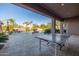 Covered patio with a ping pong table overlooks the luxurious backyard pool area at 7278 E La Junta Rd, Scottsdale, AZ 85255