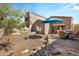 Landscaped backyard with patio furniture and umbrella at 7445 E Eagle Crest Dr # 1006, Mesa, AZ 85207