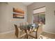 Dining area with glass table and seating for six, adjacent to the living room at 7445 E Eagle Crest Dr # 1006, Mesa, AZ 85207