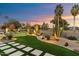 Landscaped backyard with putting green and desert plants at 8124 E Paraiso Dr, Scottsdale, AZ 85255