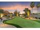 Putting green and desert landscaping at sunset at 8124 E Paraiso Dr, Scottsdale, AZ 85255