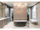 Elegant bathroom with freestanding tub, dual vanities, and chandelier at 8124 E Paraiso Dr, Scottsdale, AZ 85255