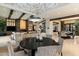 Open dining room with large round table and adjacent living area at 8124 E Paraiso Dr, Scottsdale, AZ 85255