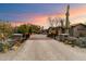 Elegant home with stone exterior, landscaped entry, and a wooden bridge at 8124 E Paraiso Dr, Scottsdale, AZ 85255