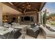 Covered patio with comfortable seating, fireplace, and built-in entertainment center at 8124 E Paraiso Dr, Scottsdale, AZ 85255