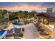 Luxury pool and spa with patio and lounge chairs at sunset at 8124 E Paraiso Dr, Scottsdale, AZ 85255