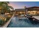 Luxury pool with fire pit and water features at sunset at 8124 E Paraiso Dr, Scottsdale, AZ 85255