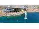 Aerial view of a modern clubhouse under construction by a lake with fountain at 10206 S Bickwell Trl, Apache Junction, AZ 85120