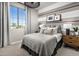 Cozy bedroom with gray bedding and mid-century furniture at 10206 S Bickwell Trl, Apache Junction, AZ 85120