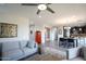 Open-concept living room with neutral walls, hardwood floors, a grey sofa, and a view into the kitchen and dining area at 10260 E White Feather Ln # 1038, Scottsdale, AZ 85262