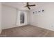 Bright bedroom with neutral carpeting, ceiling fan, and large window at 10610 S 48Th St # 2096, Phoenix, AZ 85044