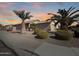 House exterior at sunset with palm trees and landscaping at 11422 W Pinehollow Dr, Surprise, AZ 85378