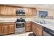 Kitchen features stainless steel appliances and light wood cabinets at 11422 W Pinehollow Dr, Surprise, AZ 85378