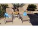 Relaxing patio with lounge chairs and side table at 11422 W Pinehollow Dr, Surprise, AZ 85378